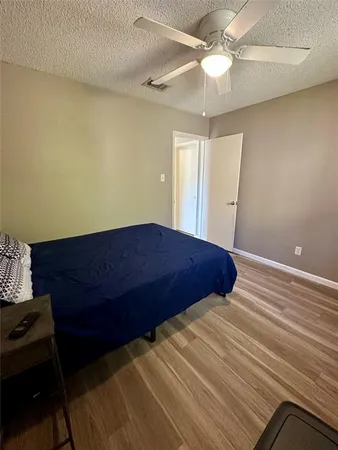 a bedroom with a bed and a ceiling fan