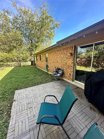 a view of backyard with patio