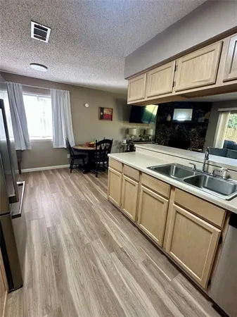 a kitchen with a sink stove and cabinets