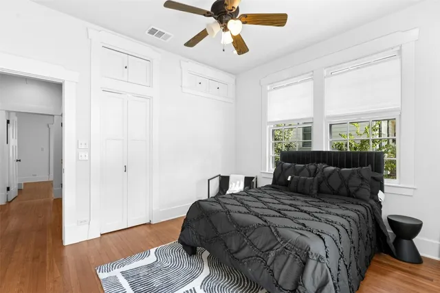 a bedroom with a bed and wooden floor