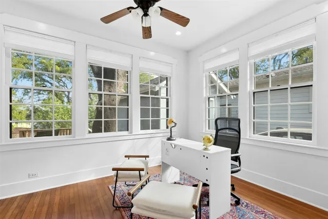 a view of a workspace with furniture and a window