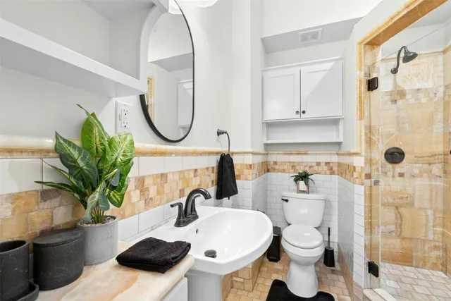 a bathroom with a sink toilet and shower