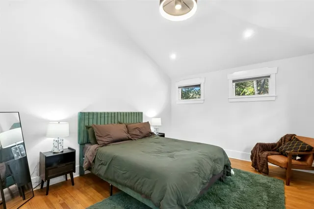 a bedroom with a bed a couch and dresser