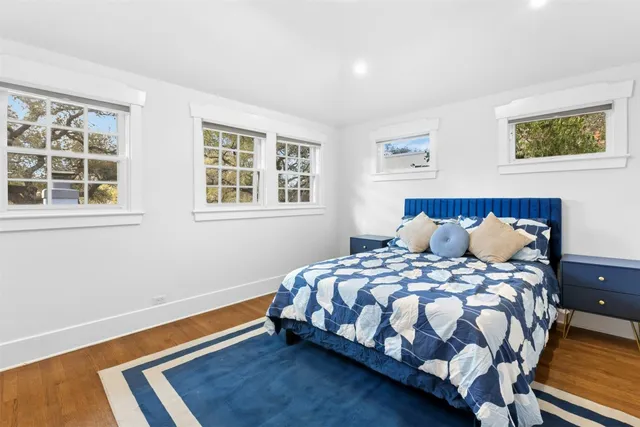 a bedroom with a bed lamp and a window