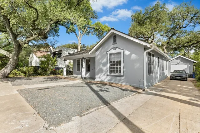 a front view of a house with a garden and yard