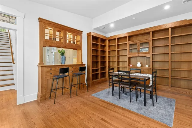 a dining room with furniture and wooden floor
