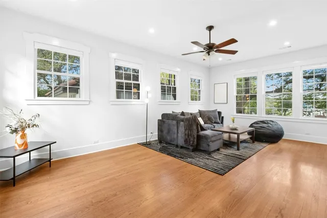 a living room with furniture ceiling fan and a window