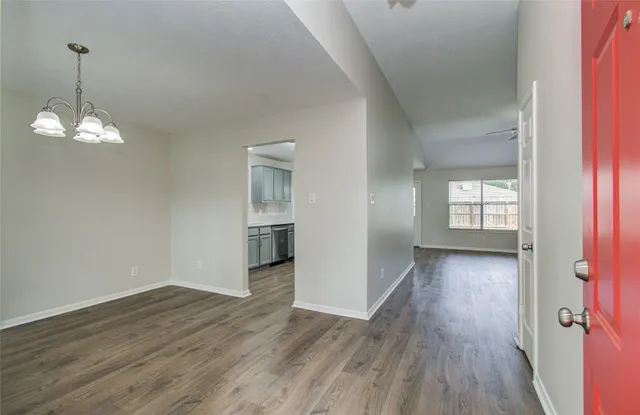 a view of a room with wooden floor and window