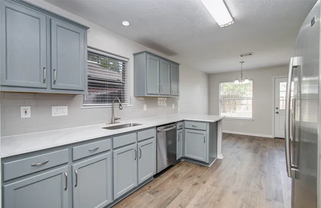 a kitchen with granite countertop white cabinets and white appliances