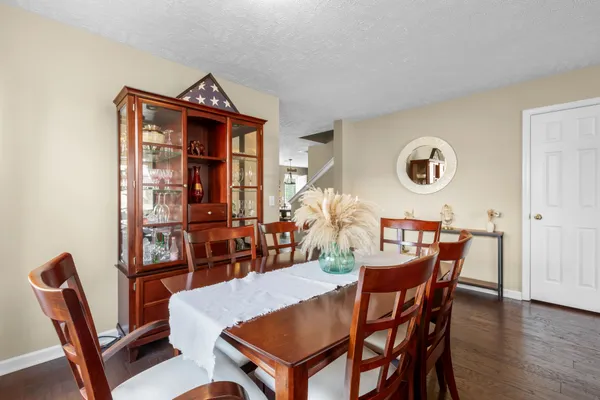 a view of a dining room with furniture and wooden floor