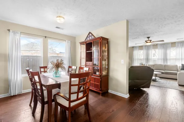 a living room with furniture a table and a large window