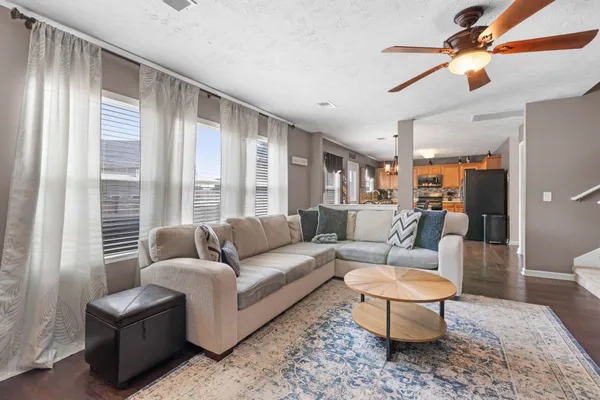 a living room with furniture a flat screen tv and a fireplace
