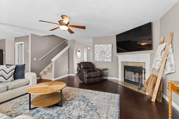 a living room with furniture a fireplace and a flat screen tv