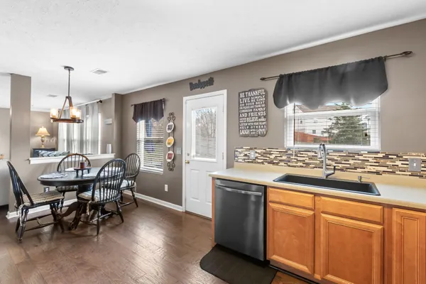 a kitchen with stainless steel appliances a stove microwave and sink