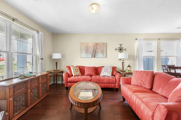 a living room with furniture a couch and a lamp