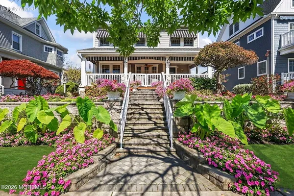 a front view of a house with a yard and fountain