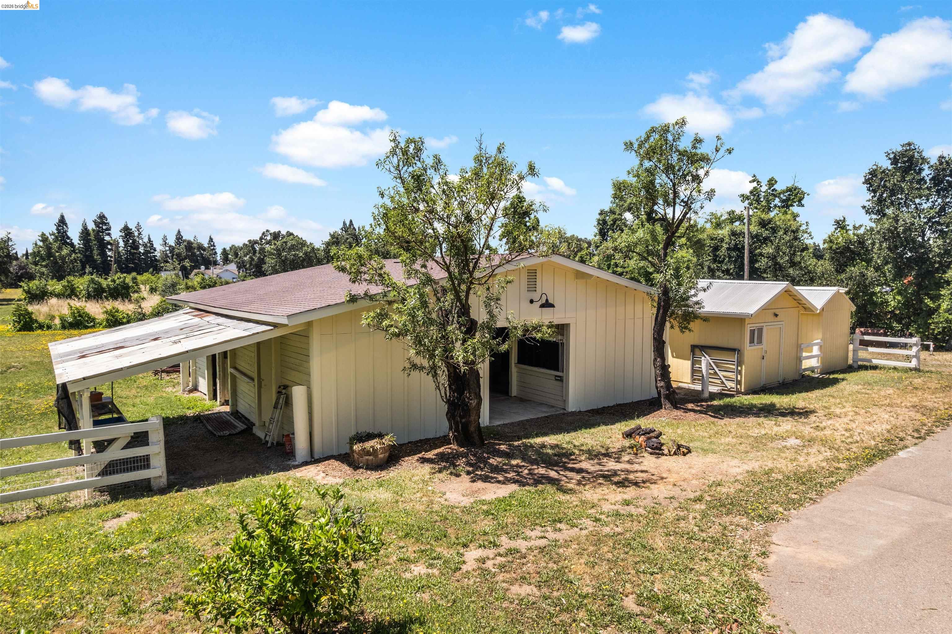 10474 Sheldon Road Elk Grove, CA 95624 - Photo 3 of 83 Exterior buildings feature light yellow siding and brown roofing