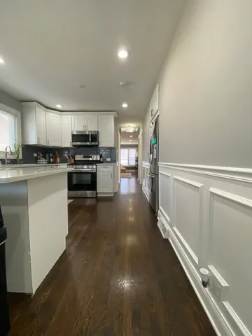 a kitchen with a sink stainless steel appliances and cabinets