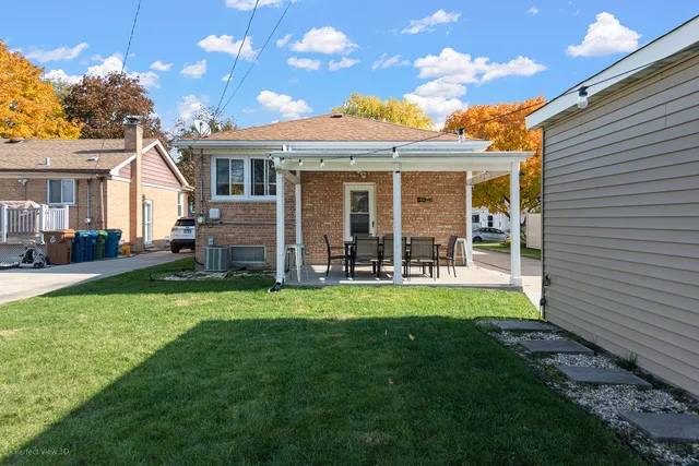 a view of a house with a backyard porch and sitting area