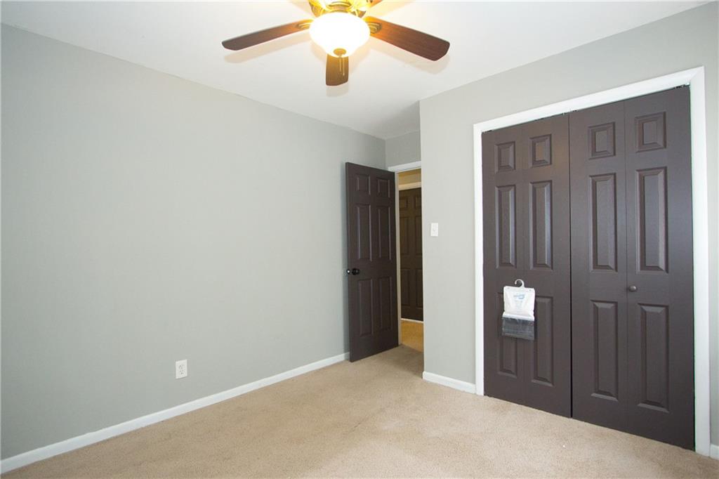 2974 McGlynn Court Decatur, GA 30034 - Photo 18 of 28 an empty room with closet and a chandelier fan