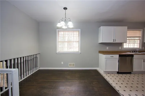 a kitchen with granite countertop a stove a sink and a window