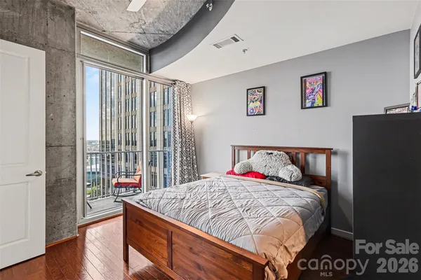 a bed sitting in a bedroom next to a window