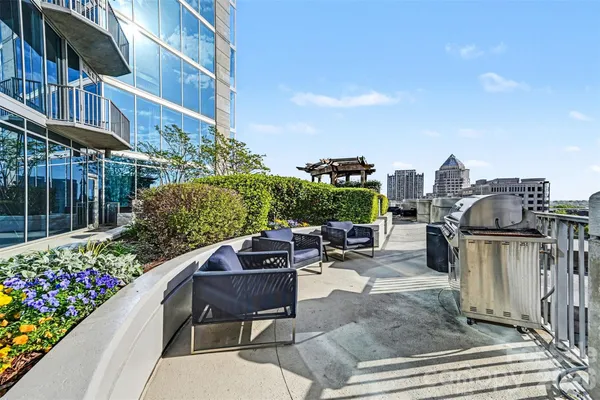a swimming pool with outdoor seating and yard