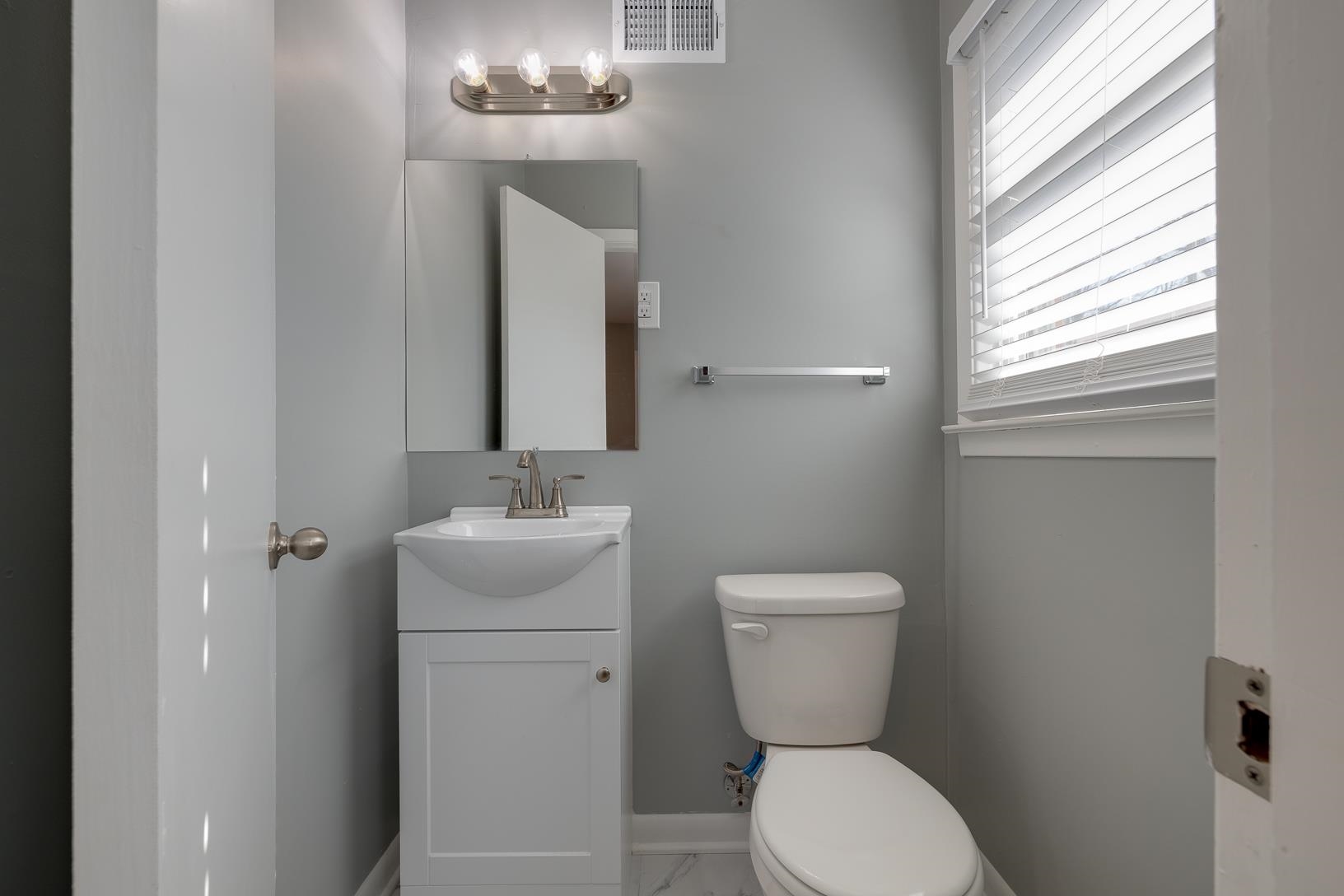1490 Wilbec Road Memphis, TN 38117 - Photo 16 of 19 a bathroom with a toilet a sink and a mirror