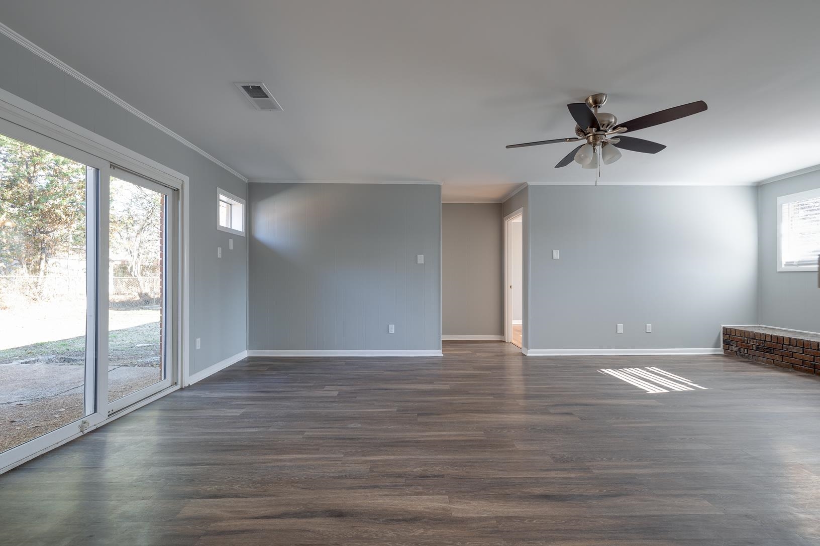 1490 Wilbec Road Memphis, TN 38117 - Photo 8 of 19 wooden floor in an empty room with a window