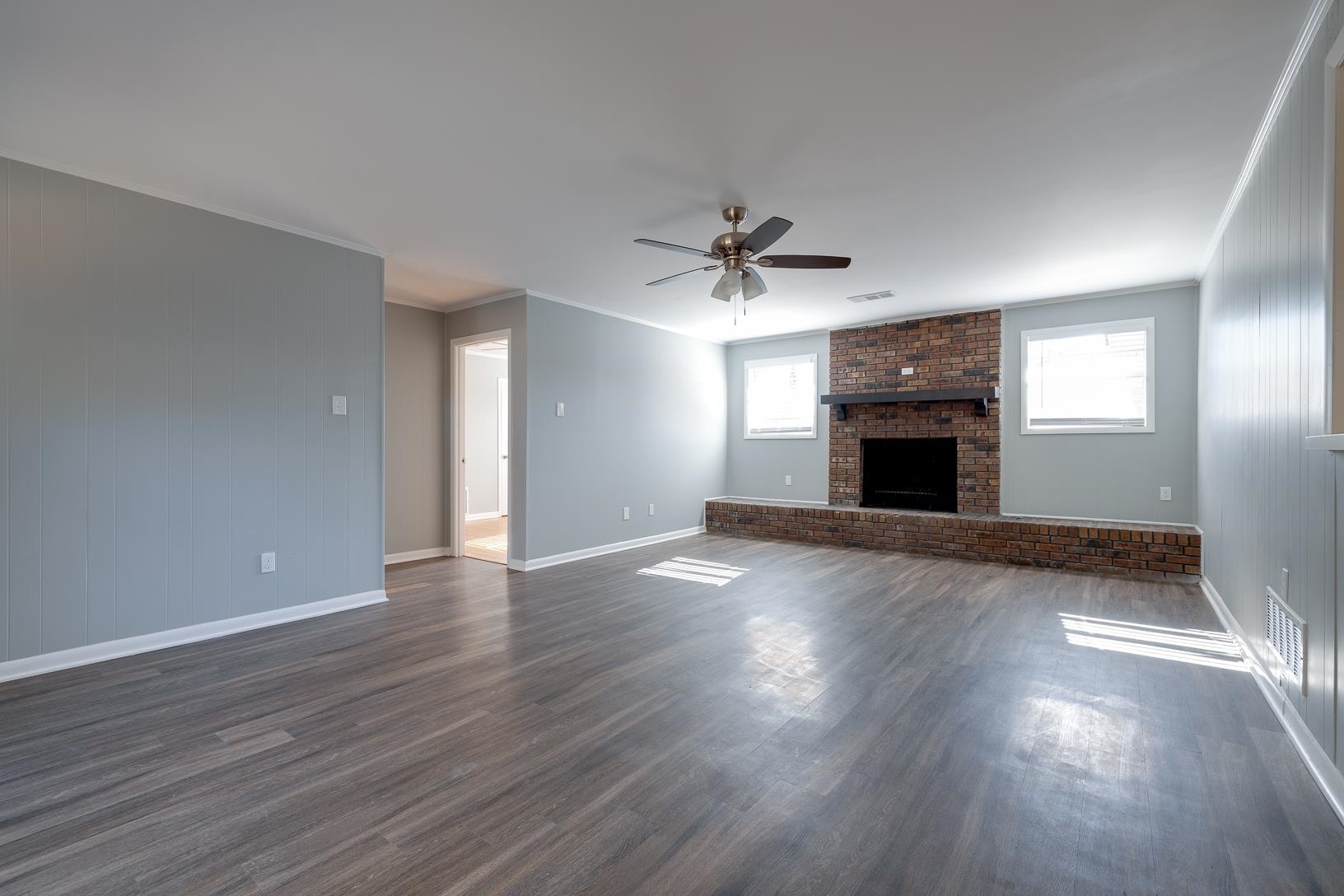 1490 Wilbec Road Memphis, TN 38117 - Photo 9 of 19 a view of empty room with wooden floor and fireplace