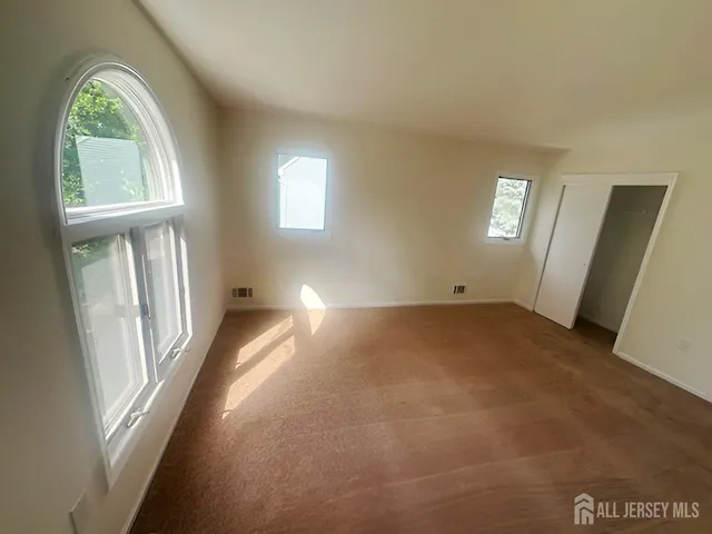 a view of empty room with windows