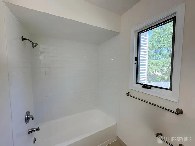 a white bath tub sitting next to a window