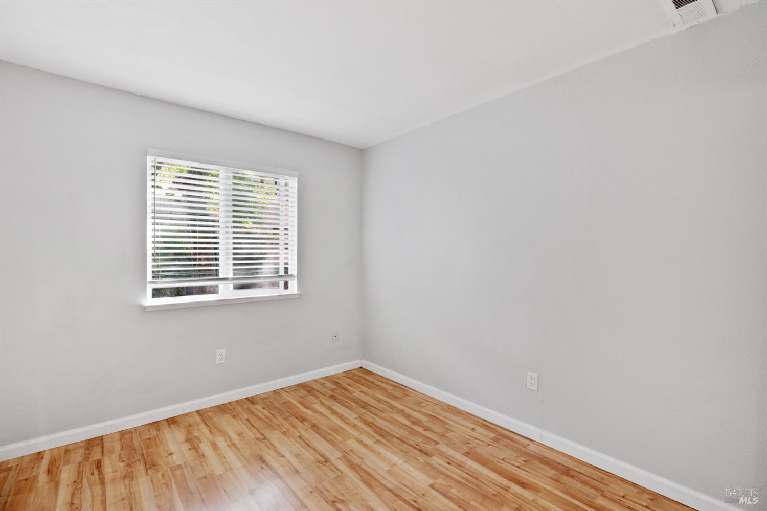 7651 Camino Colegio Rohnert Park, CA 94928 - Photo 13 of 15 a view of an empty room with wooden floor and a window