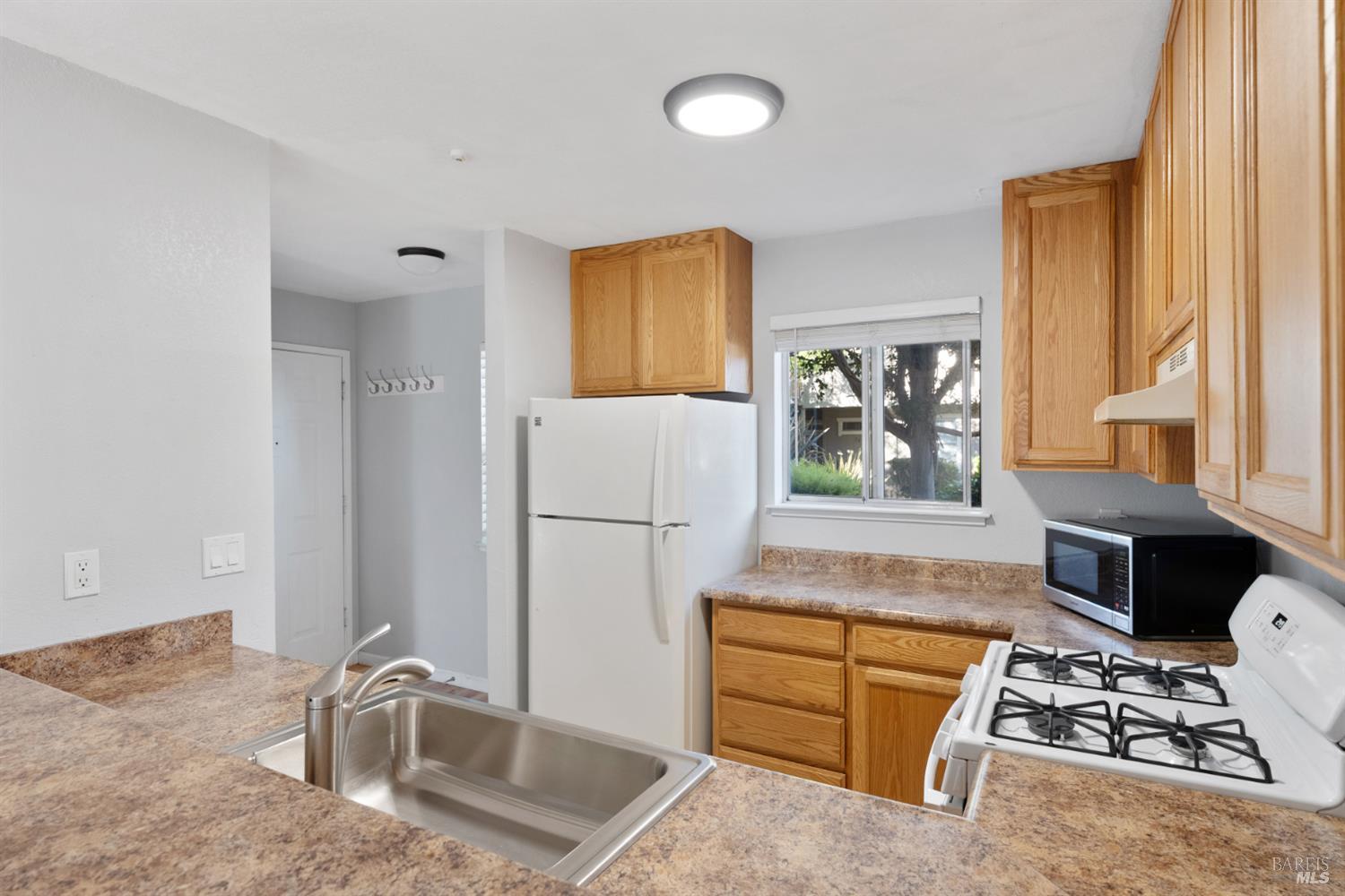 7651 Camino Colegio Rohnert Park, CA 94928 - Photo 5 of 15 a kitchen with stainless steel appliances granite countertop a refrigerator and a stove top oven