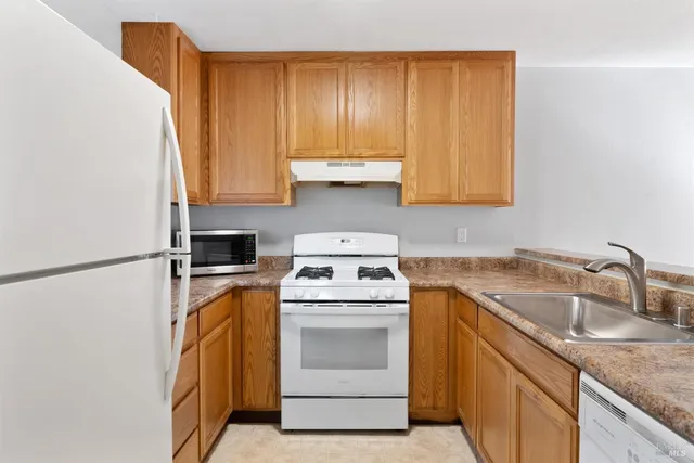 a kitchen with a sink stove and refrigerator