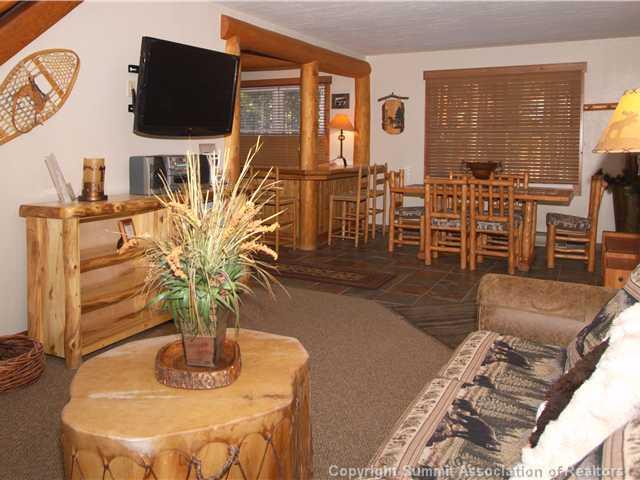 407 4 O'Clock Run Road Breckenridge, CO 80424 - Photo 1 of 25 a living room with furniture a flat screen tv and kitchen view