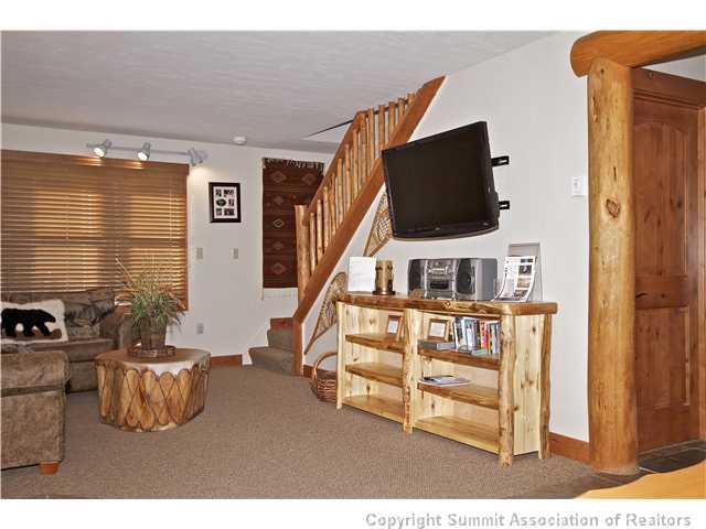 407 4 O'Clock Run Road Breckenridge, CO 80424 - Photo 2 of 25 a living room with furniture and a flat screen tv
