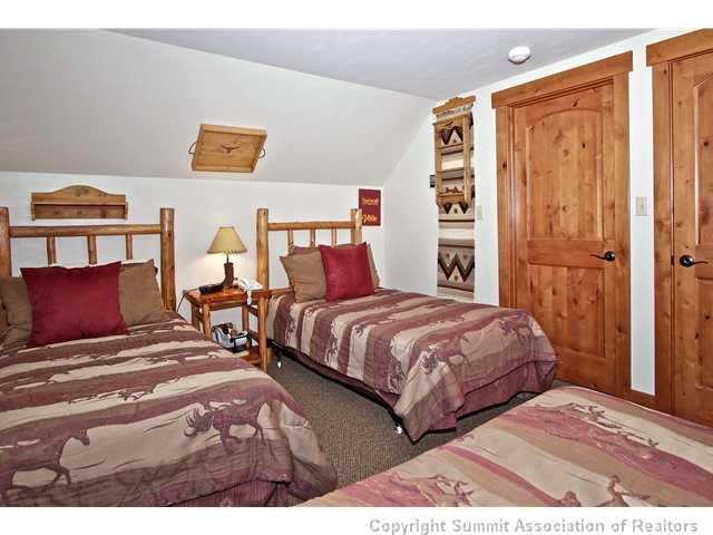 407 4 O'Clock Run Road Breckenridge, CO 80424 - Photo 12 of 25 a bedroom with a bed and painting on the wall