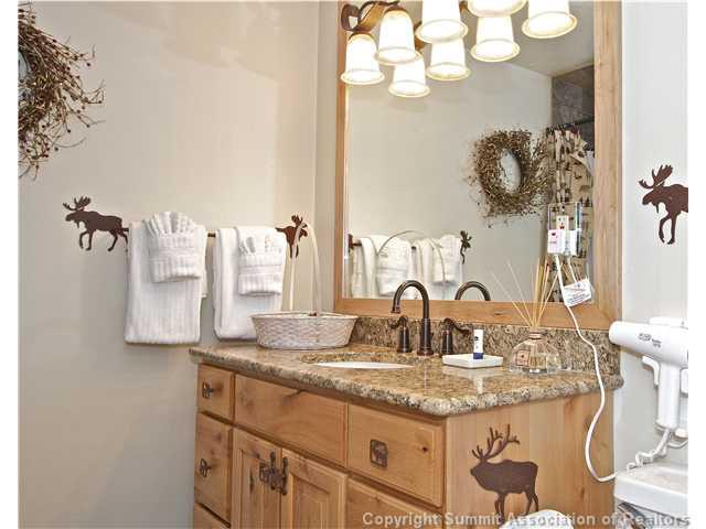 407 4 O'Clock Run Road Breckenridge, CO 80424 - Photo 14 of 25 a bathroom with a granite countertop sink a large mirror and vanity