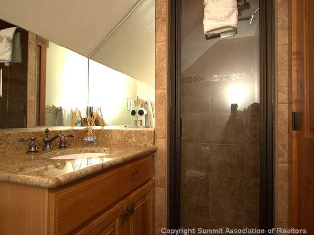 407 4 O'Clock Run Road Breckenridge, CO 80424 - Photo 16 of 25 a bathroom with a granite countertop sink and a mirror