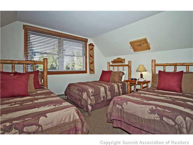 407 4 O'Clock Run Road Breckenridge, CO 80424 - Photo 22 of 25 a bedroom with two beds and a large window