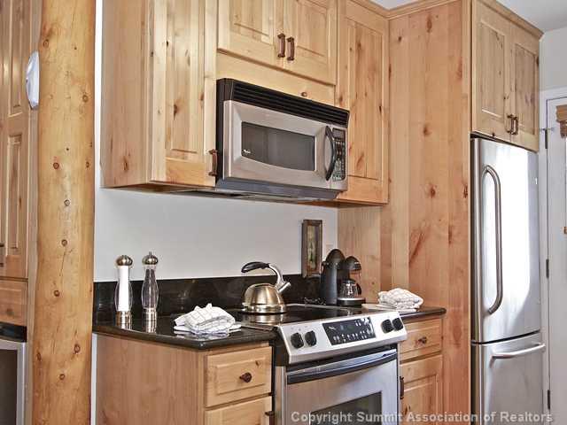 407 4 O'Clock Run Road Breckenridge, CO 80424 - Photo 5 of 25 a kitchen with stainless steel appliances granite countertop a refrigerator and a stove top oven