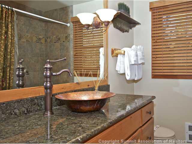 407 4 O'Clock Run Road Breckenridge, CO 80424 - Photo 8 of 25 a bathroom with a granite countertop sink and a mirror