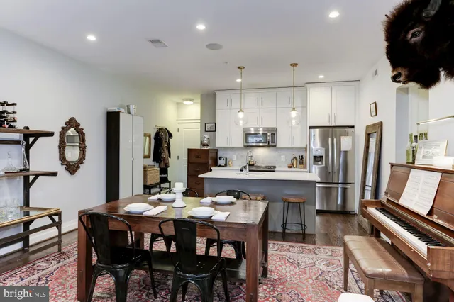 a kitchen with stainless steel appliances kitchen island granite countertop a sink and a stove