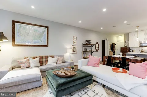 a living room with furniture and a lamp