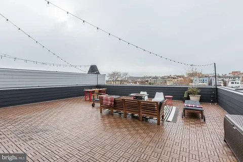 a view of a terrace with furniture and stove