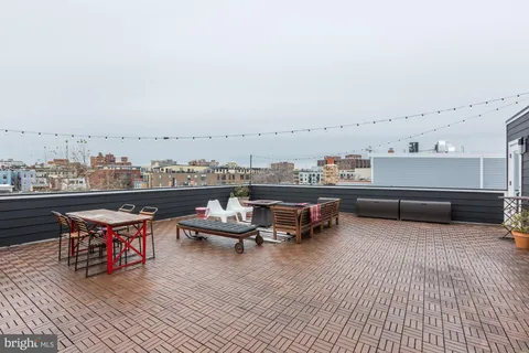 a kitchen with stainless steel appliances kitchen island granite countertop a sink a stove and cabinets
