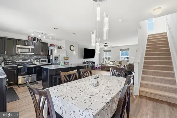a large kitchen with a table and chairs