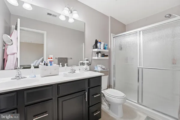 a bathroom with a sink vanity mirror and toilet
