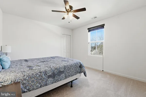 a bedroom with a bed dresser and a window